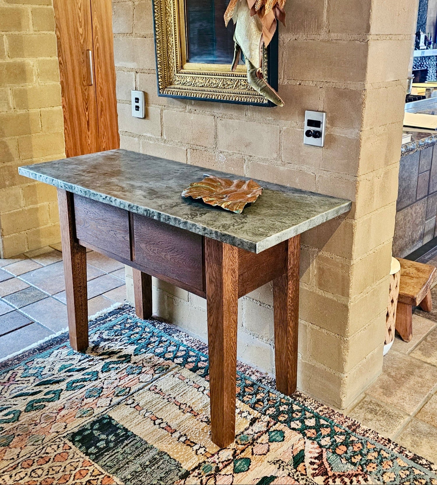 A hallway table made in the farmhouse style with marble top